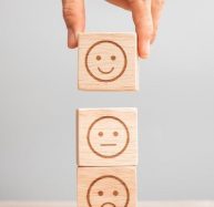 Man hand holding emotion face block Customer choose Emoticon for user reviews Service rating ranking customer review satisfaction evaluation and feedback concept _ Premium Photo